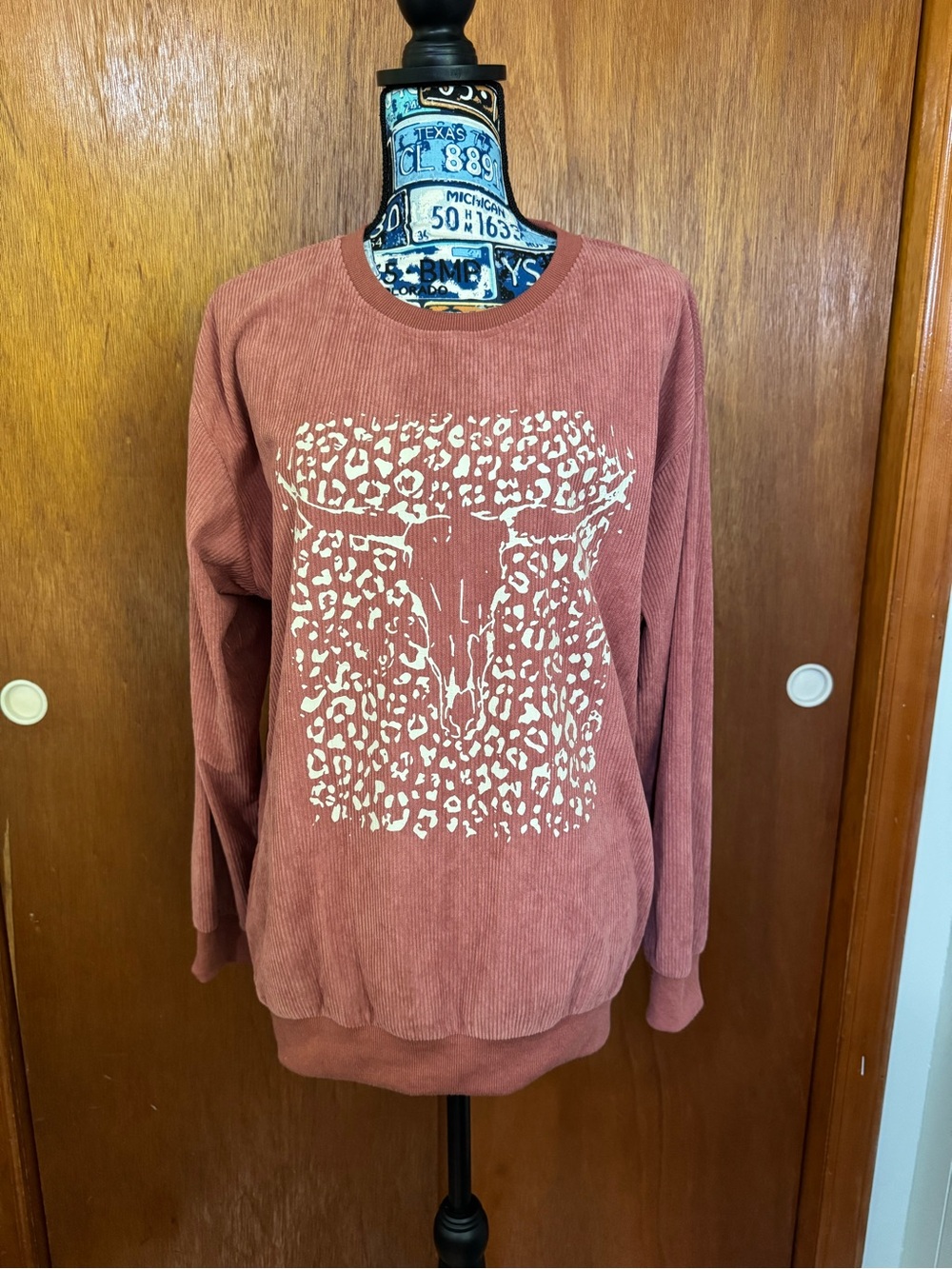 Rust Long Sleeve Crewneck Sweatshirt with White Leopard Skull Print